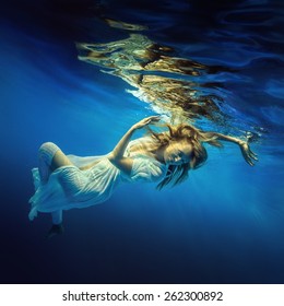 Woman Swims Underwater In A Beautiful Dress