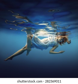 Woman Swims Underwater In A Beautiful Dress