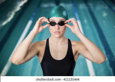 Woman Swimsuit Adjusting Her Goggles Pool Stock Photo 411131464 ...