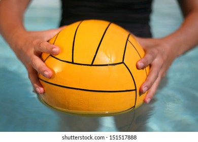 Woman In Swimsuit Holding A Water Polo Ball In The Pool. 