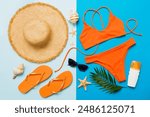 Woman swimwear and beach accessories flat lay top view. Top view with bikini outfit on color background. Vacation concept copy space.