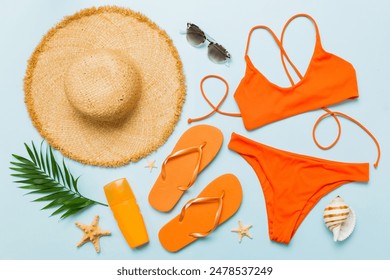 Woman swimwear and beach accessories flat lay top view. Top view with bikini outfit on color background. Vacation concept copy space. - Powered by Shutterstock