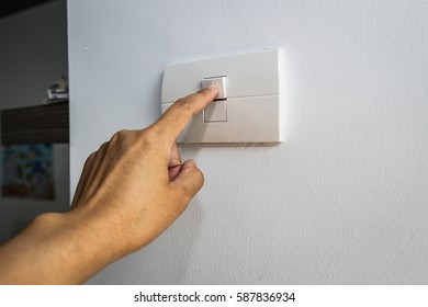woman switches off the light