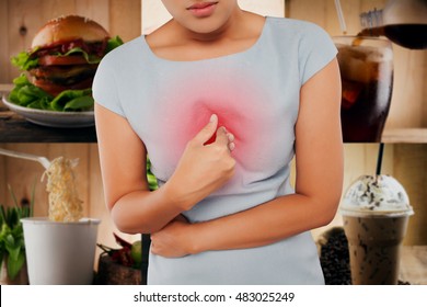 Woman With Symptomatic Acid Reflux, On Food Background