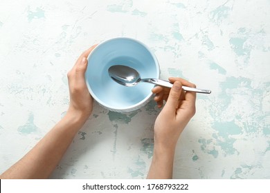 Woman At Table With Clean Bowl And Spoon, Top View