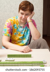 Woman At The Table Playing Mahjong