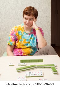 Woman At The Table Playing Mahjong