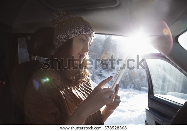Woman with the tablet in a\
car