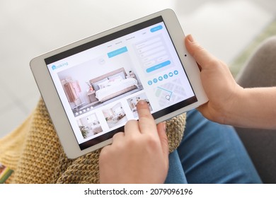 Woman with tablet computer booking room in hotel at home - Shutterstock ID 2079096196