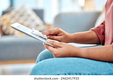 Woman, tablet and wipe screen for dust, clean and remove bacteria in living room. Female, girl and device disinfection, microfiber cloth and dirty to clear surface and hygiene for filthy and cleaning - Powered by Shutterstock