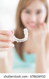 woman take invisible braces  and smile at home - Shutterstock ID 678636910