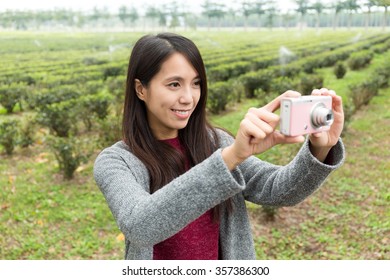 Woman take a photo by using camera - Shutterstock ID 357386300