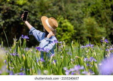 Woman take selfie on phone in the flower garden - Powered by Shutterstock