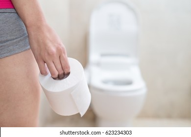 Woman Take Toilet Paper In The Bathroom