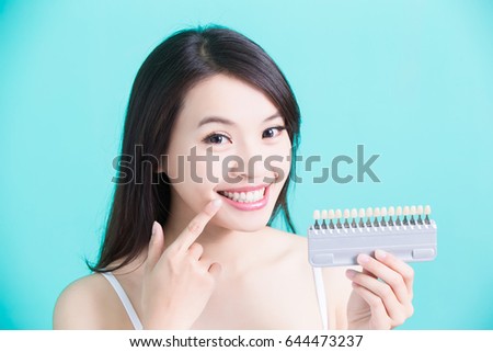 woman take tooth color palette with whiten concept