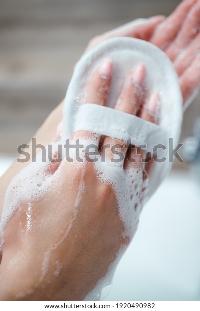The woman takes\
a bath and washes her body with a washcloth for a shower. Bath\
foam, shower gel, body care