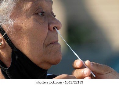 A Woman Takes A COVID-19 Test During A Free COVID-19 Testing In Los Angeles, Wednesday, Nov. 25, 2020.  (Ringo Chiu Via AP)