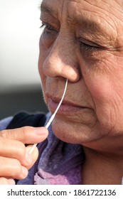 A Woman Takes A COVID-19 Test During A Free COVID-19 Testing In Los Angeles, Wednesday, Nov. 25, 2020.  (Ringo Chiu Via AP)