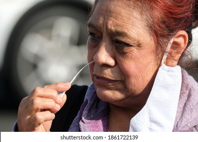 A Woman Takes A COVID-19 Test During A Free COVID-19 Testing In Los Angeles, Wednesday, Nov. 25, 2020.  (Ringo Chiu Via AP)