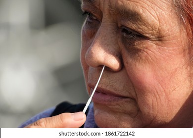 A Woman Takes A COVID-19 Test During A Free COVID-19 Testing In Los Angeles, Wednesday, Nov. 25, 2020.  (Ringo Chiu Via AP)