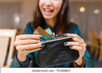 Woman Takes The Credit Card Out Of Wallet In Restaurant