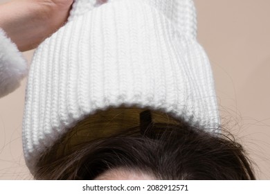 Woman takes off her hat and her hair is electrified close up concept.