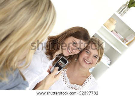 woman takes a photograph with mobile telephone
