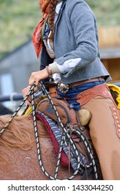 A woman takes to the saddle to help with a horse roundup.