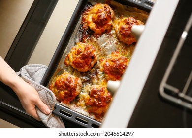 Woman Taking Baking Tray With Minced Meat Boats, Mushrooms And Cheese Out Of Oven