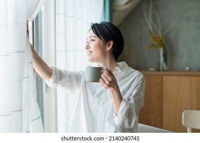 Woman taking a break while working remotely - Shutterstock ID 2140240745