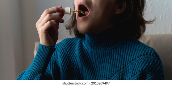 Woman Taking Cbd Oil Under Tongue - Alternative Medicine Concept - Focus On Dropper