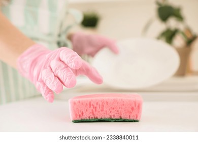 Woman taking cleaning sponge in kitchen, closeup - Powered by Shutterstock