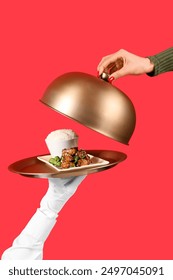 Woman taking cloche from tasty Chinese dish on red background, closeup