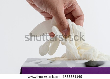 Woman taking disposable gloves from the box