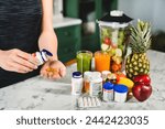 Woman taking food supplements instead of fresh fruits and vegetables. Dietary healthy eating, body slimming and losing weight. Medicine for burning fat and calories