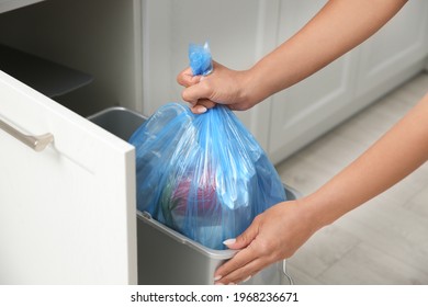 Woman Taking Garbage Bag Out Of Bin At Home, Closeup