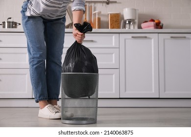 Woman Taking Garbage Bag Out Of Bin At Home, Closeup