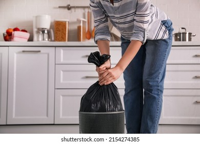 Woman Taking Garbage Bag Out Of Bin At Home, Closeup