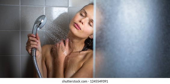 Woman Taking A Long Hot Shower Washing Her Hair In A Modern Design Bathroom