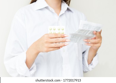 Woman Taking Medicine. Beautiful Young Female Holding Blister Pack With Pills In Hand And Reading Medical Instructions. Attractive Girl Looking At Instruction, Holding Pill Package. High Resolution - Shutterstock ID 1772017913