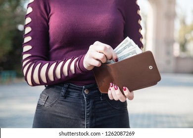 Woman Taking Money From Her Wallet. 