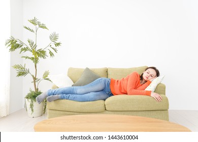 Woman taking a nap at home - Shutterstock ID 1443610004