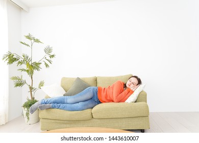 Woman taking a nap at home - Shutterstock ID 1443610007