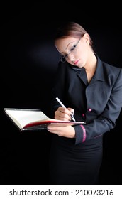 Woman Taking Notes While Talking on Phone
