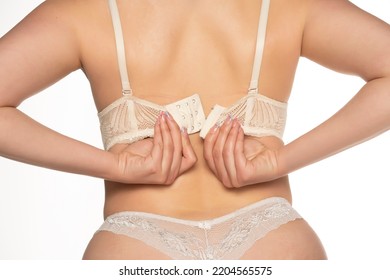 Woman Taking Off Her Bra, Back View, Isolated On White.