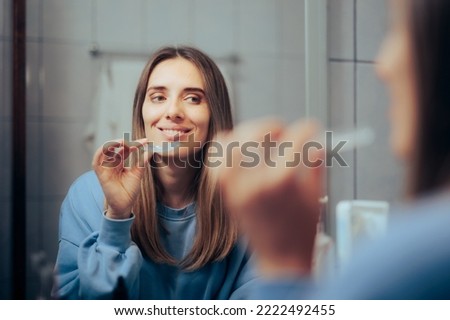 
Woman Taking off Her Clear Retainer in the Bathroom Mirror
Girl using teeth grinding protection at night 
