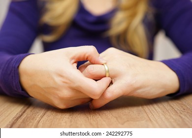 Woman Is Taking Off The Wedding Ring