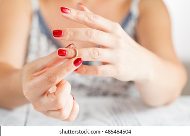 Woman Taking Off The Wedding Ring