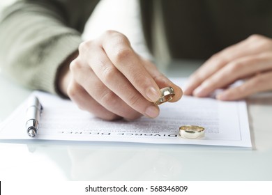 Woman Taking Off Wedding Ring