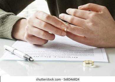 Woman Taking Off Wedding Ring